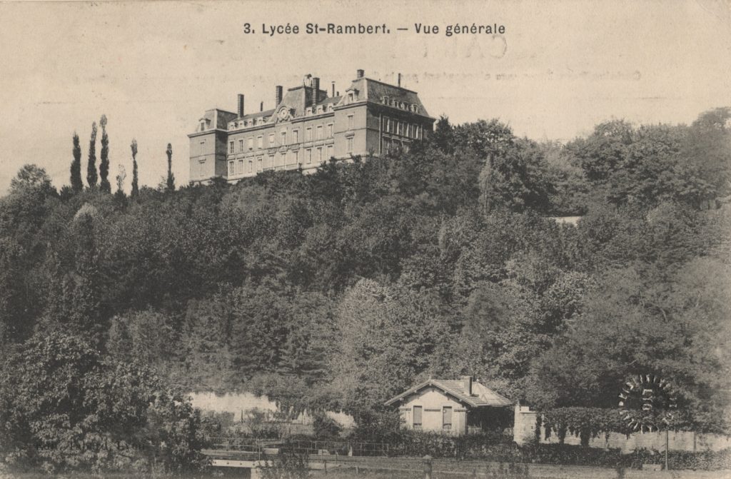 Black and white postcard showing a large building on a hill
