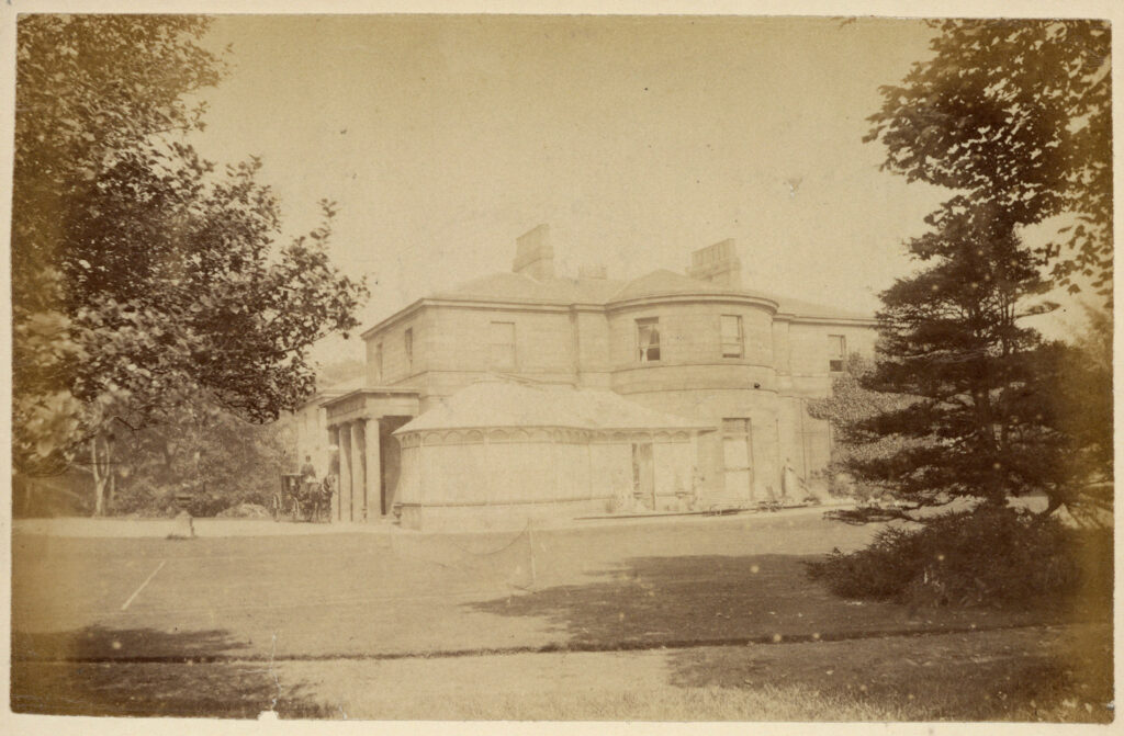 Sepia photograph of the entrance porch and bow windows of Sandyford Lodge,, c. 1890s